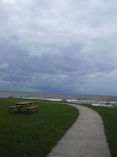 A picnic table sits at one edge of Sylvan Beach on Lake Oneida